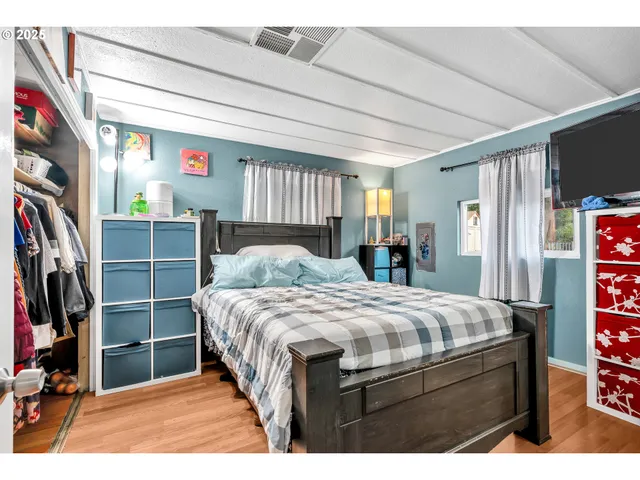 a bedroom with a bed closet and a window