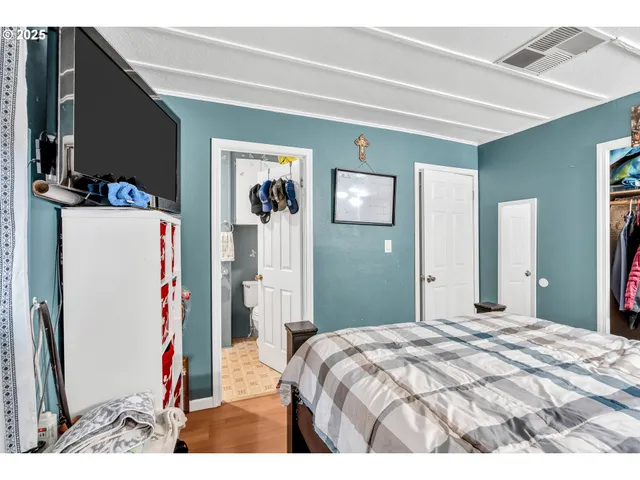 a bedroom with a bed and a flat screen tv