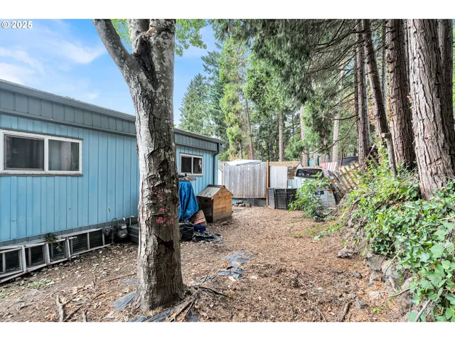 a backyard of a house with barbeque oven table and chairs