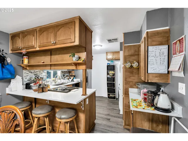 a kitchen view of a center island and a stove