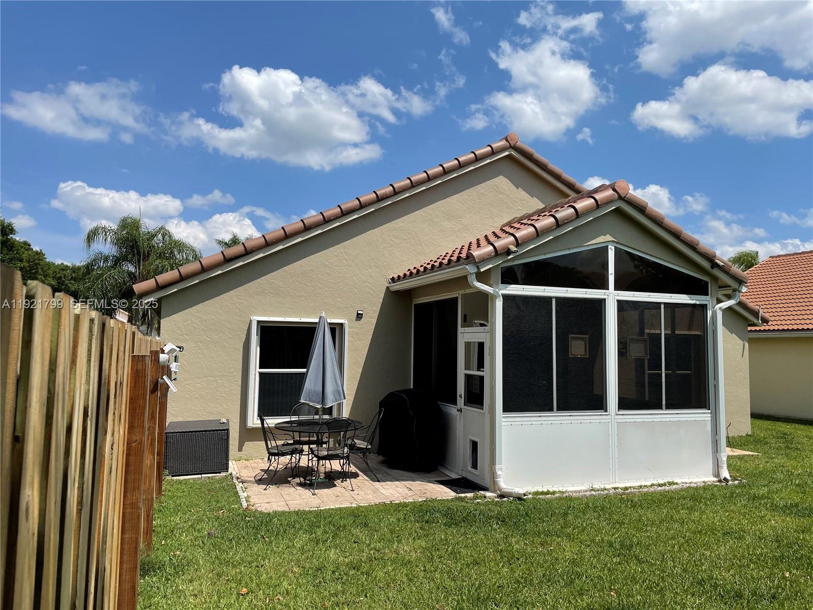 1972 Oak Berry Circle, Unit 1972 Wellington, FL 33414 - Photo 2 of 13 a view of a house with backyard sitting area and garden