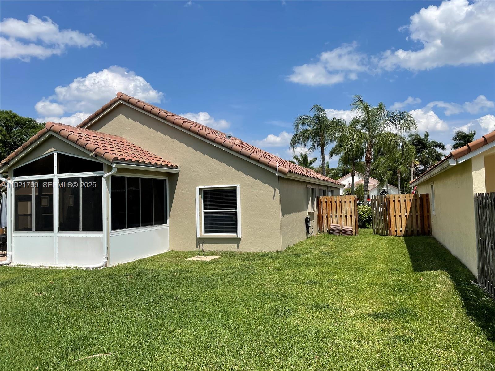 1972 Oak Berry Circle, Unit 1972 Wellington, FL 33414 - Photo 3 of 13 a house that has a big yard with large trees