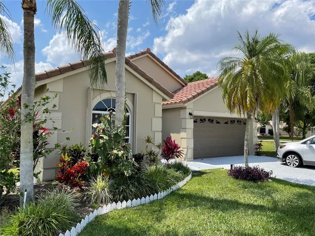 a front view of house with yard and outdoor seating
