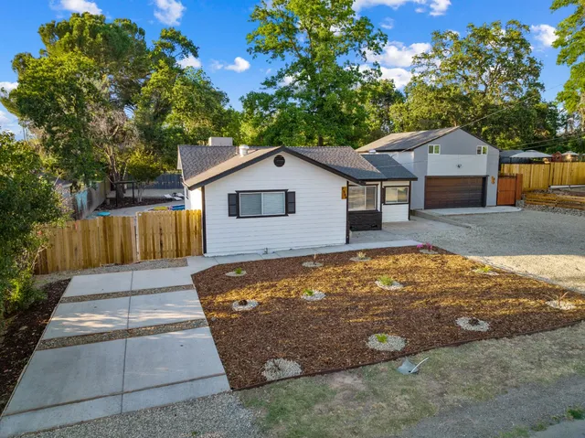 an aerial view of a house with garden space and street view