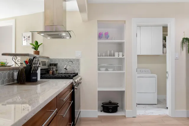 a view of a dining room with furniture a chandelier and wooden floor