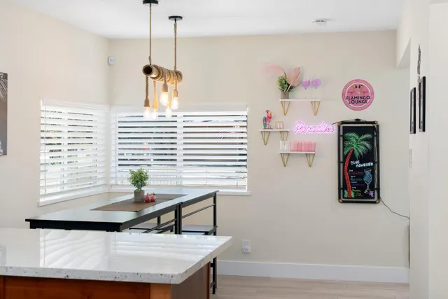 a view of a chair and table in the back yard of the house