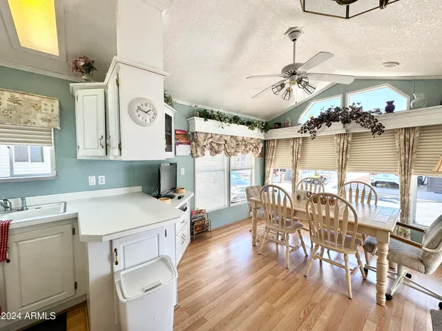 a living room with furniture a fireplace and a chandelier