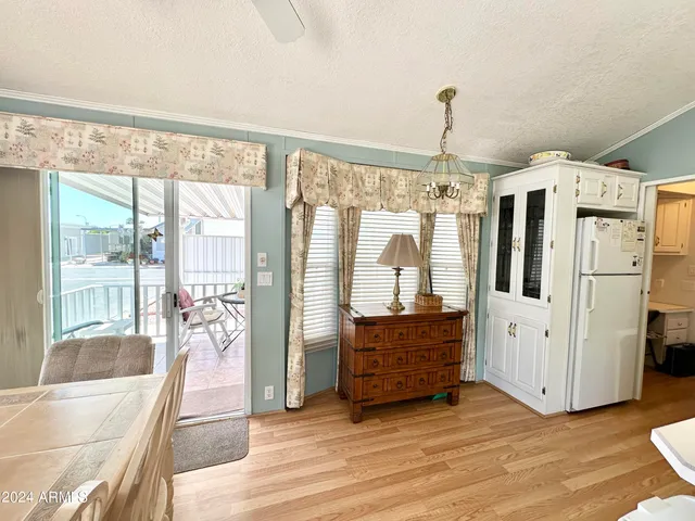 a hallway with cabinets and wooden floor