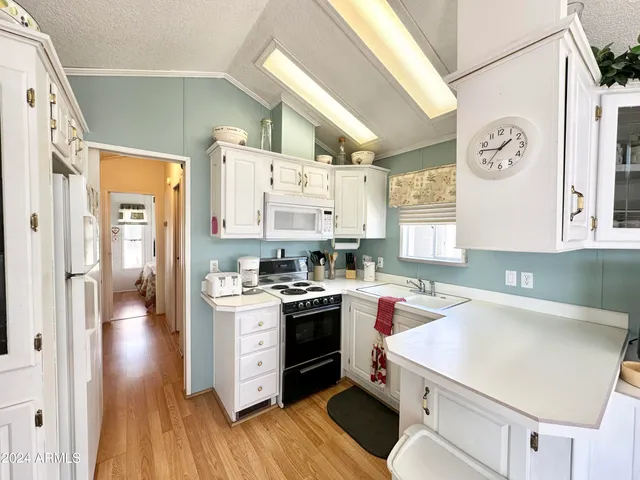 a kitchen with a stove a sink and a refrigerator