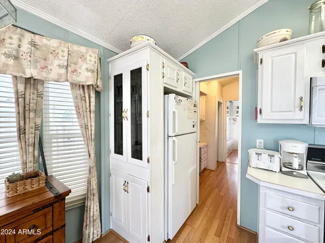 a kitchen with stainless steel appliances a refrigerator sink and cabinets