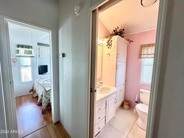 a white toilet sitting next to a bathroom sink