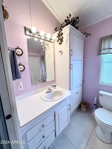 a bathroom with a sink vanity mirror and toilet