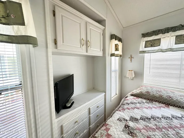 a bedroom with a bed cabinet and a window