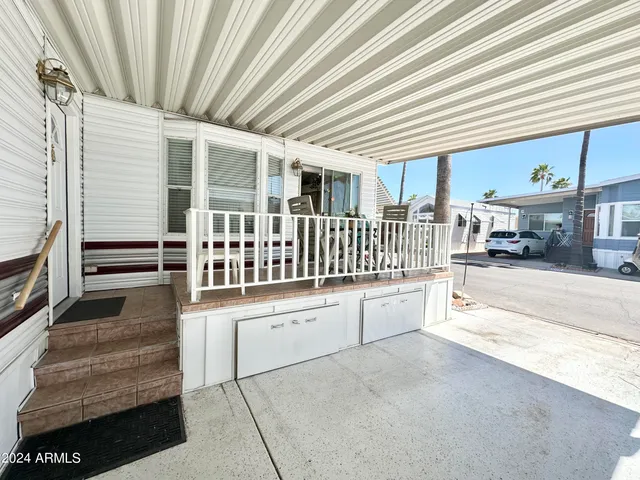 a view of a porch with wooden floor and fence
