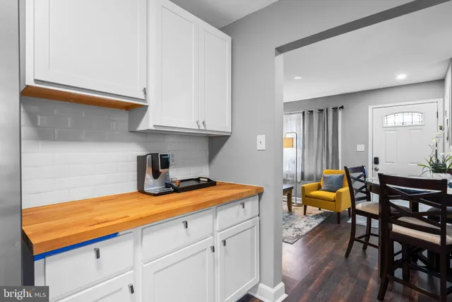 a kitchen with stainless steel appliances granite countertop a sink dishwasher and cabinets with wooden floor