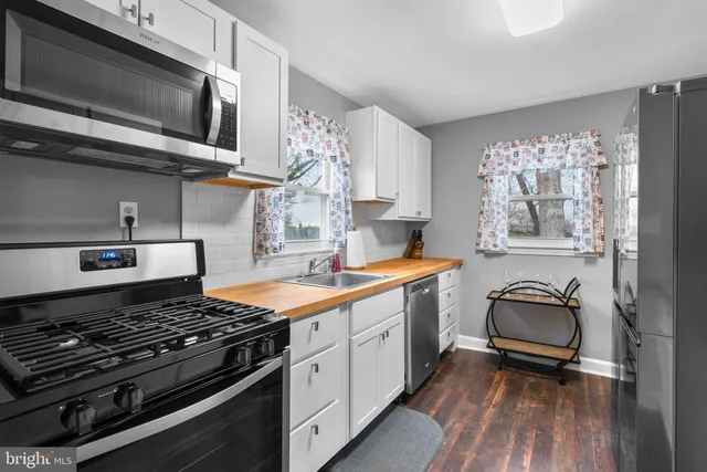 a kitchen with stainless steel appliances granite countertop a stove and a sink