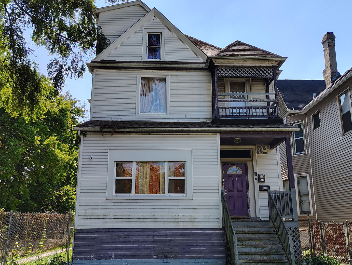 a view of a house with wooden fence and large windows