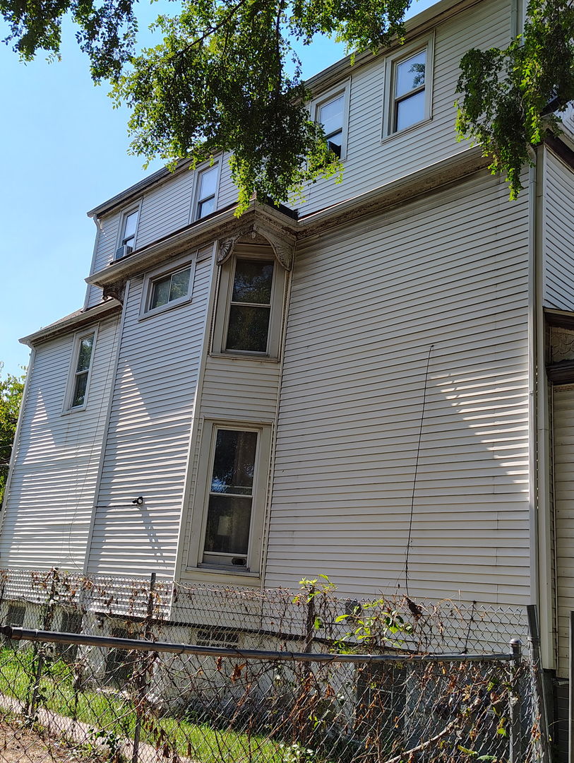 415 West 62nd Street Chicago, IL 60621 - Photo 5 of 5 a view of a house with a yard