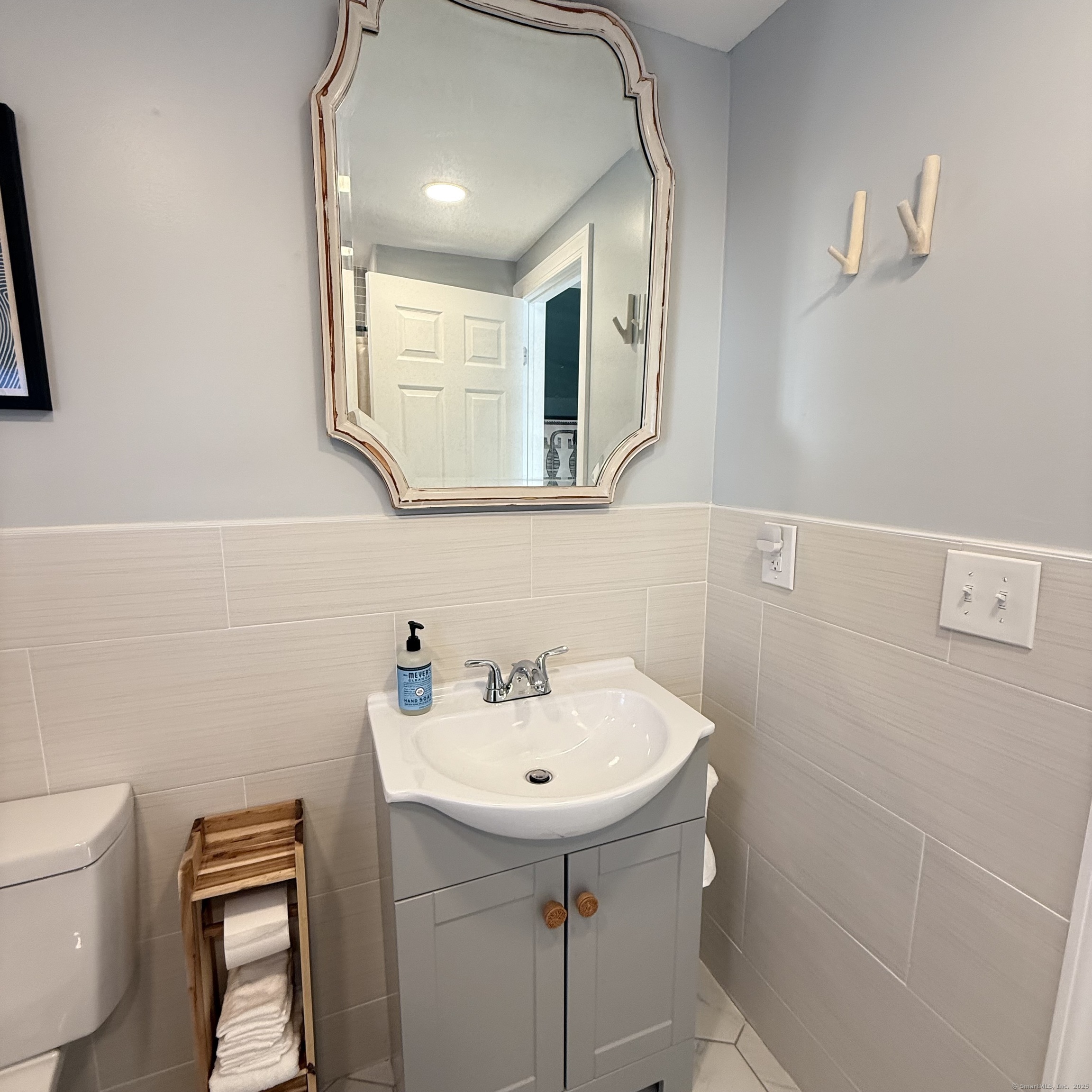 68-70 Black Point Road East Lyme, CT 06357 - Photo 4 of 26 a bathroom with a sink a toilet and mirror