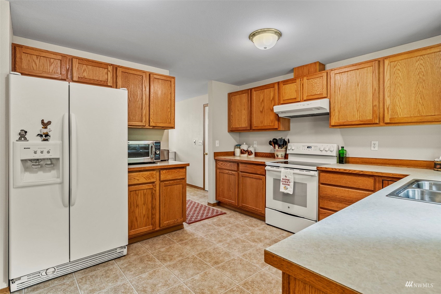 658 Smokey Valley Road Toledo, WA 98591 - Photo 15 of 40 a kitchen with stainless steel appliances granite countertop a refrigerator a sink dishwasher a stove top oven a refrigerator and white cabinets with wooden floor