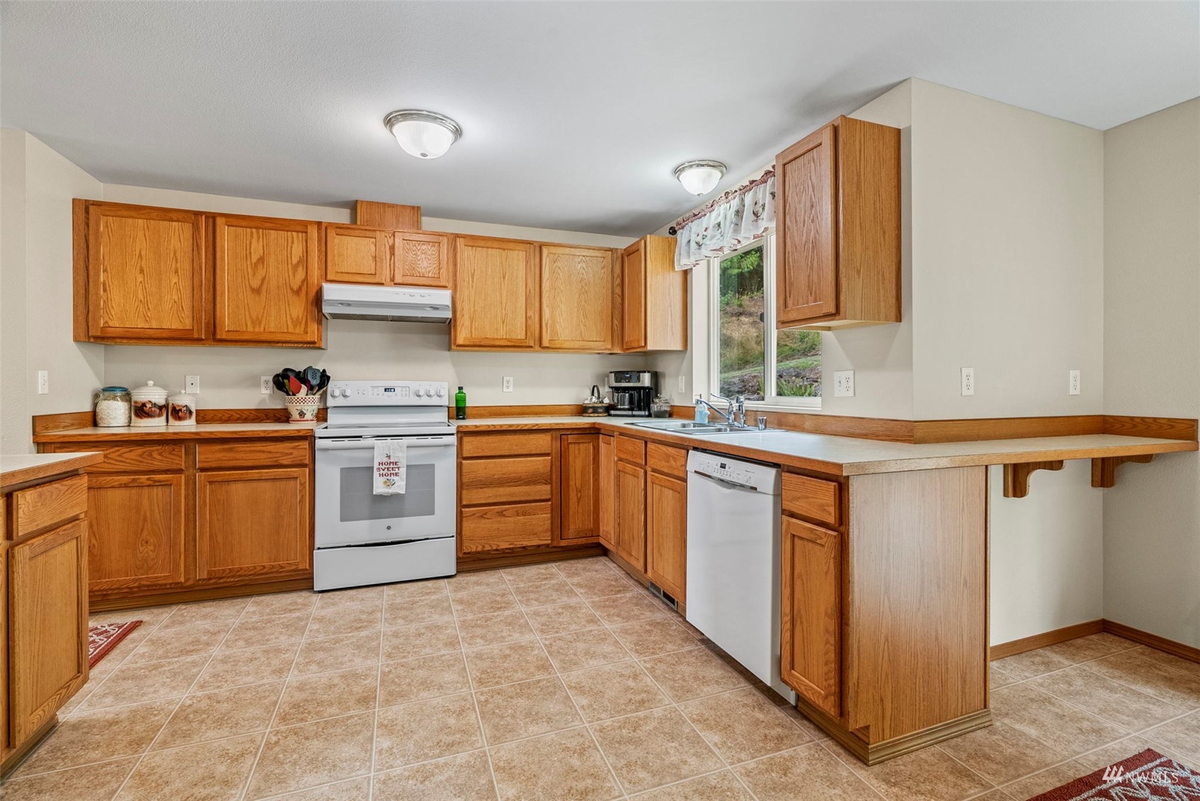 658 Smokey Valley Road Toledo, WA 98591 - Photo 17 of 40 a kitchen with stainless steel appliances granite countertop a sink counter space cabinets and a large window