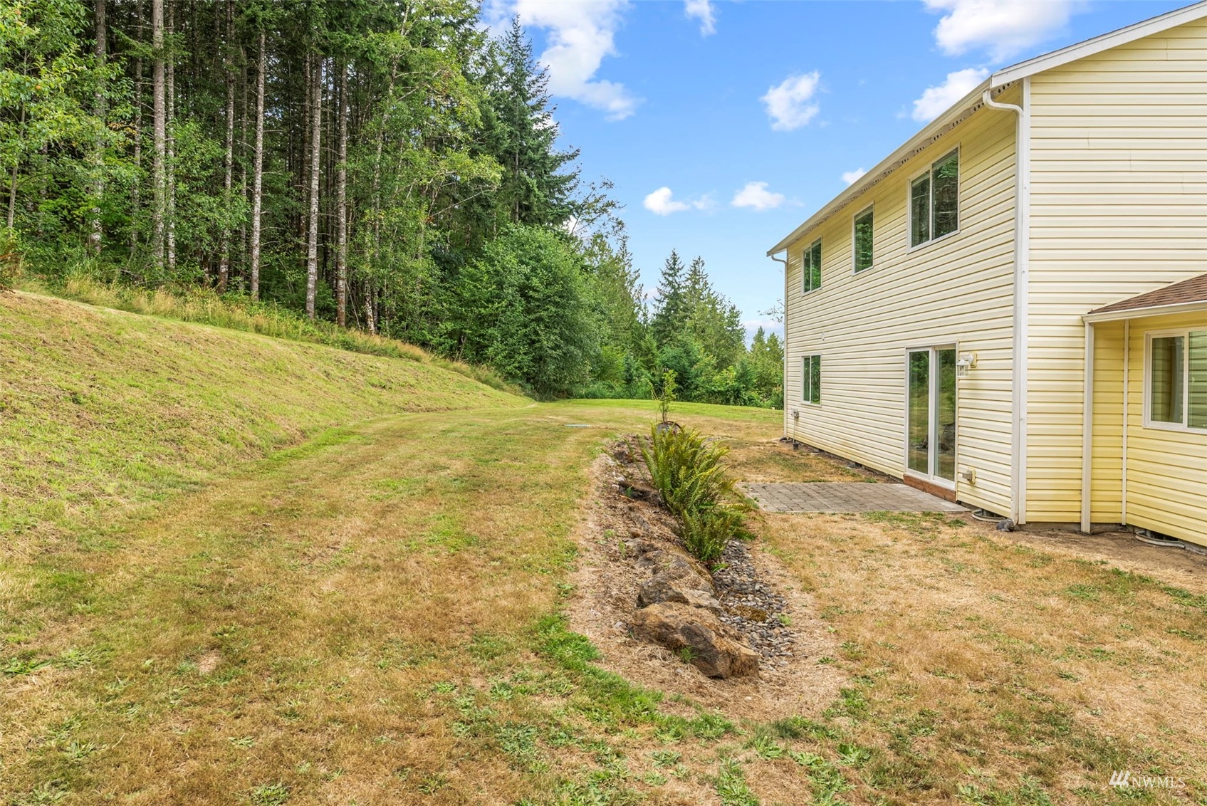 658 Smokey Valley Road Toledo, WA 98591 - Photo 32 of 40 a backyard of a house with large trees and plants
