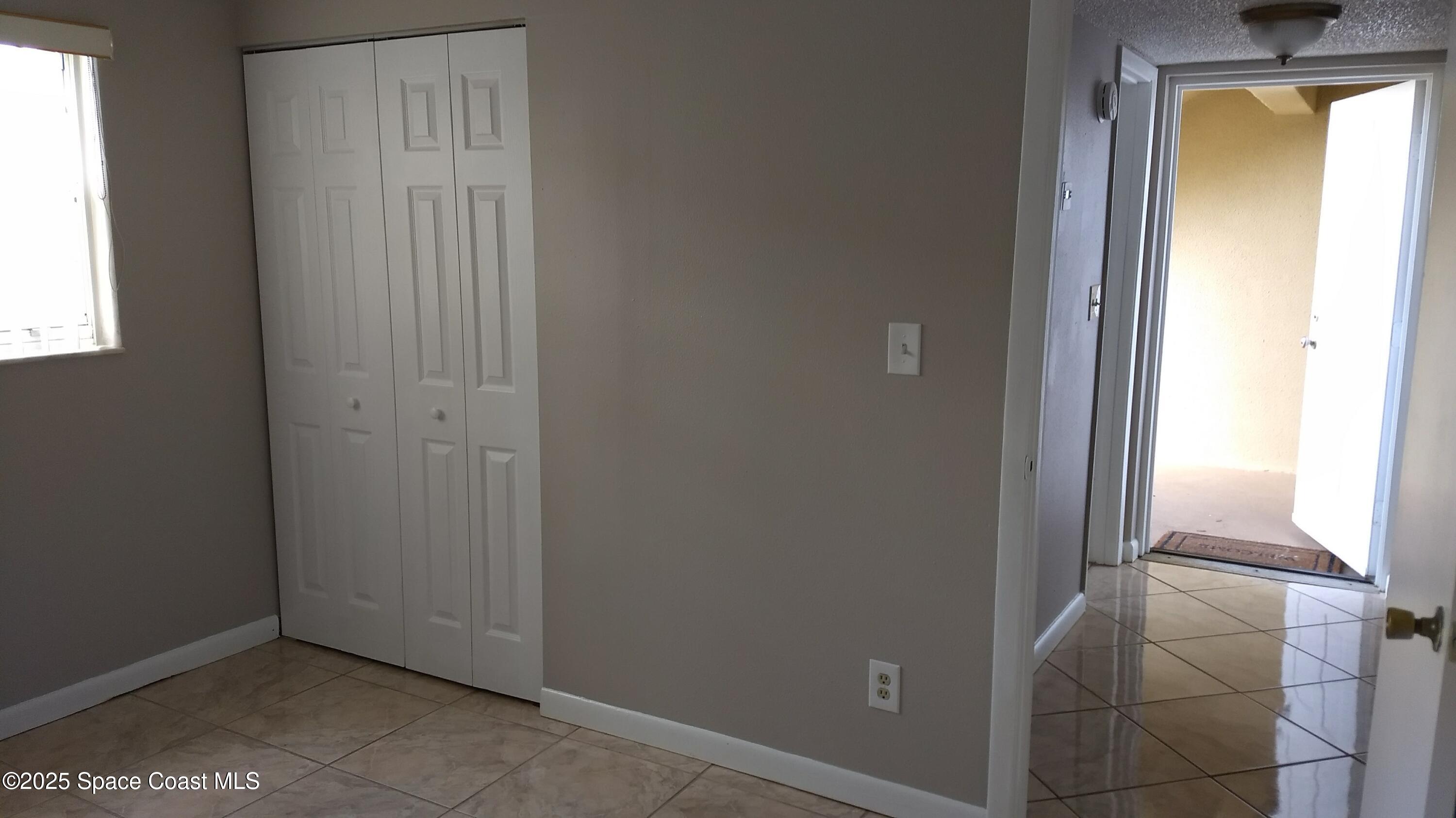 1609 Sunny Brook Lane, Unit E 104 Palm Bay, FL 32905 - Photo 13 of 31 an empty room with windows and closet