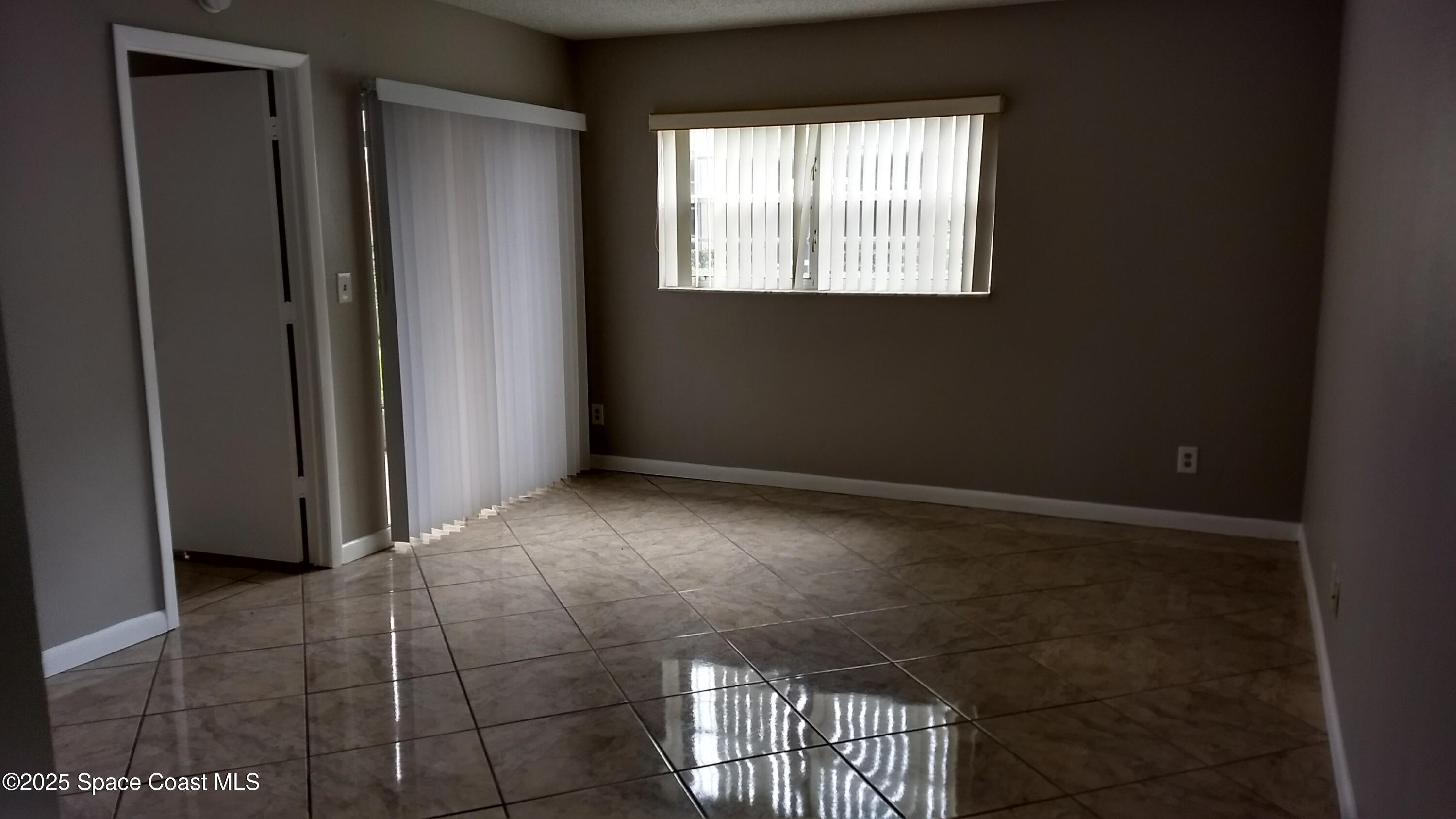 1609 Sunny Brook Lane, Unit E 104 Palm Bay, FL 32905 - Photo 16 of 31 a view of an empty room with a window