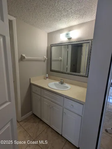 a bathroom with a sink and mirror