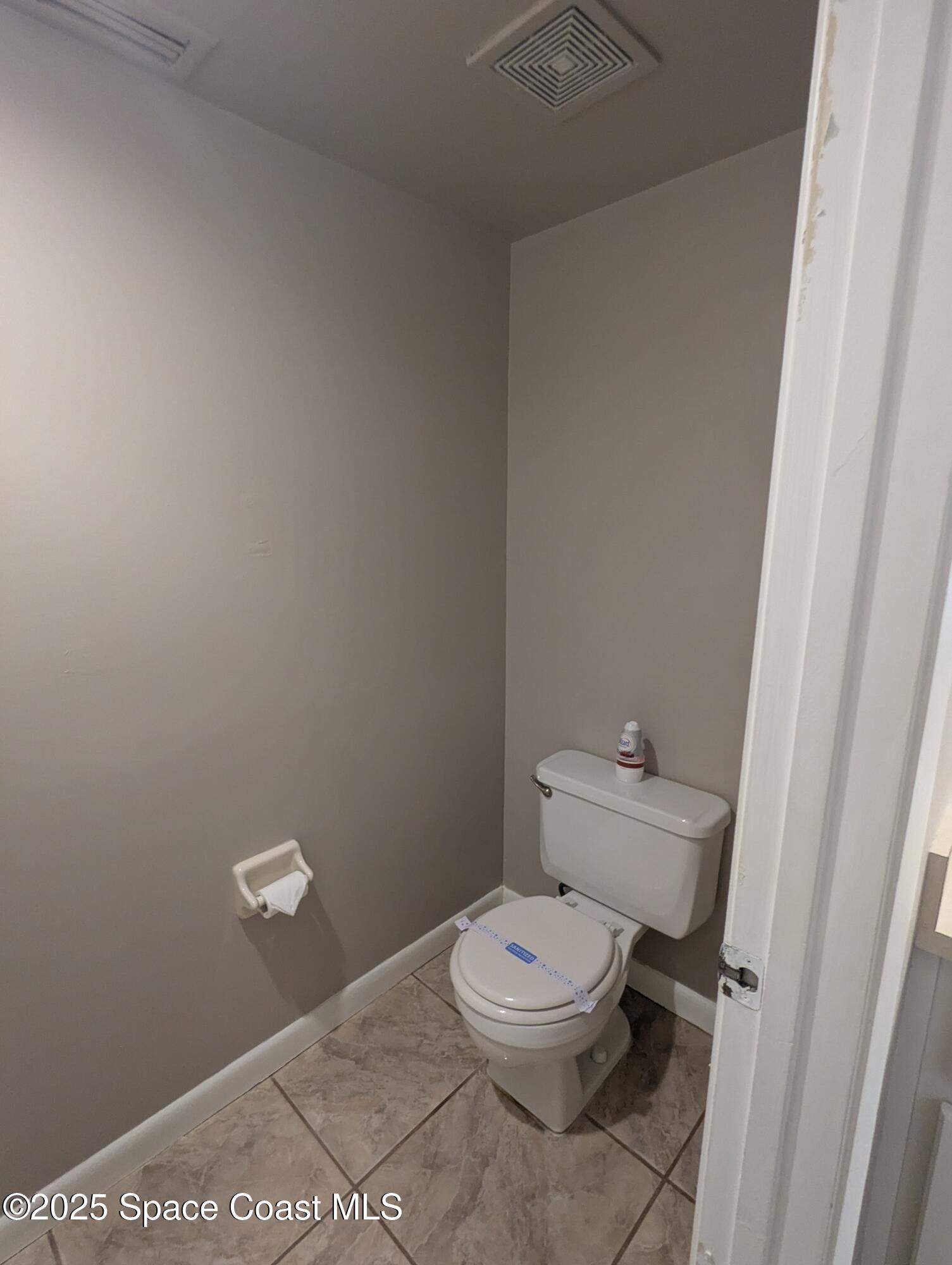 1609 Sunny Brook Lane, Unit E 104 Palm Bay, FL 32905 - Photo 23 of 31 a white toilet sitting next to a shower