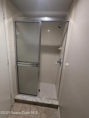 a bathroom with a glass door shower