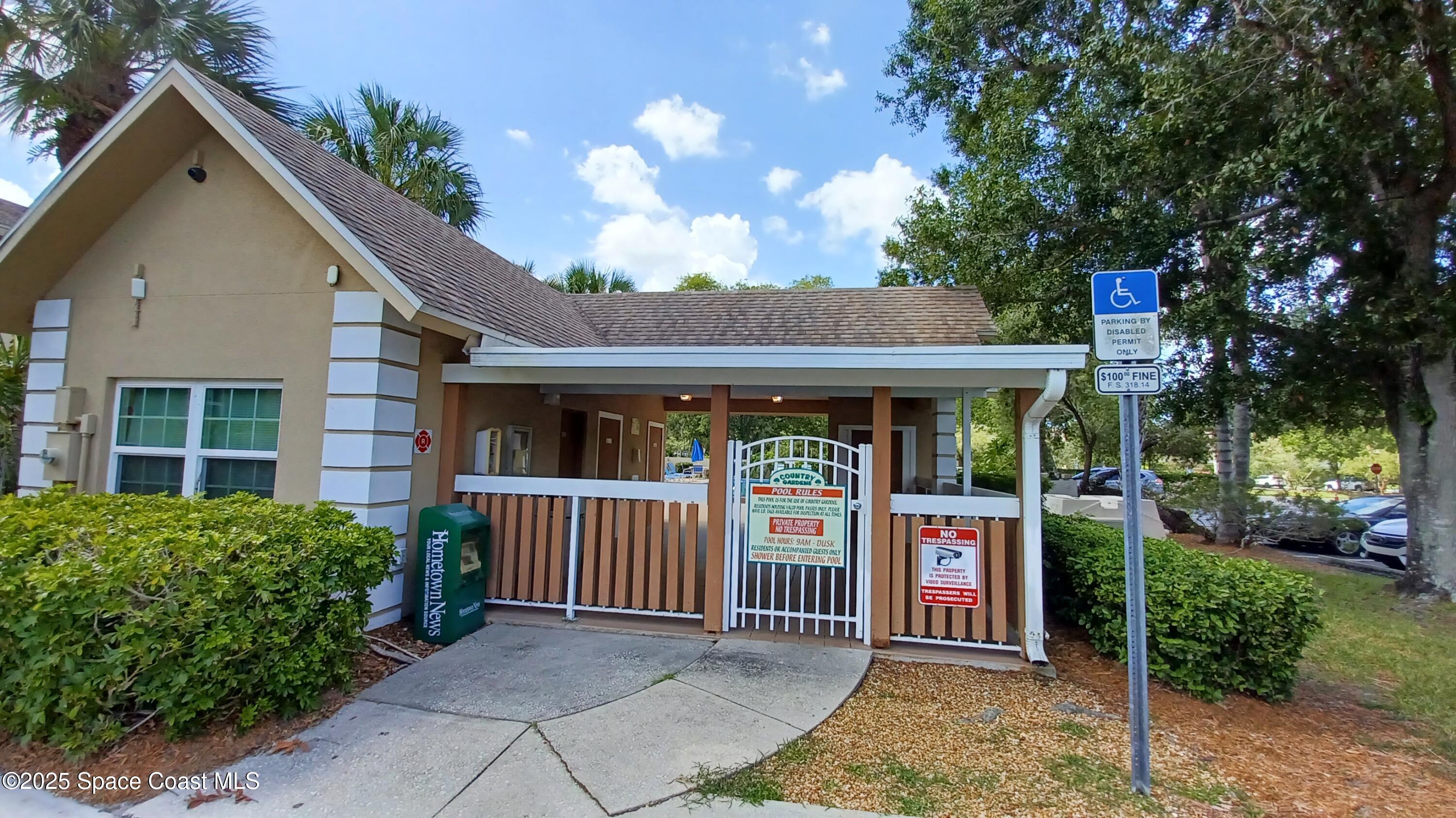 1609 Sunny Brook Lane, Unit E 104 Palm Bay, FL 32905 - Photo 28 of 31 a front view of a house with garden