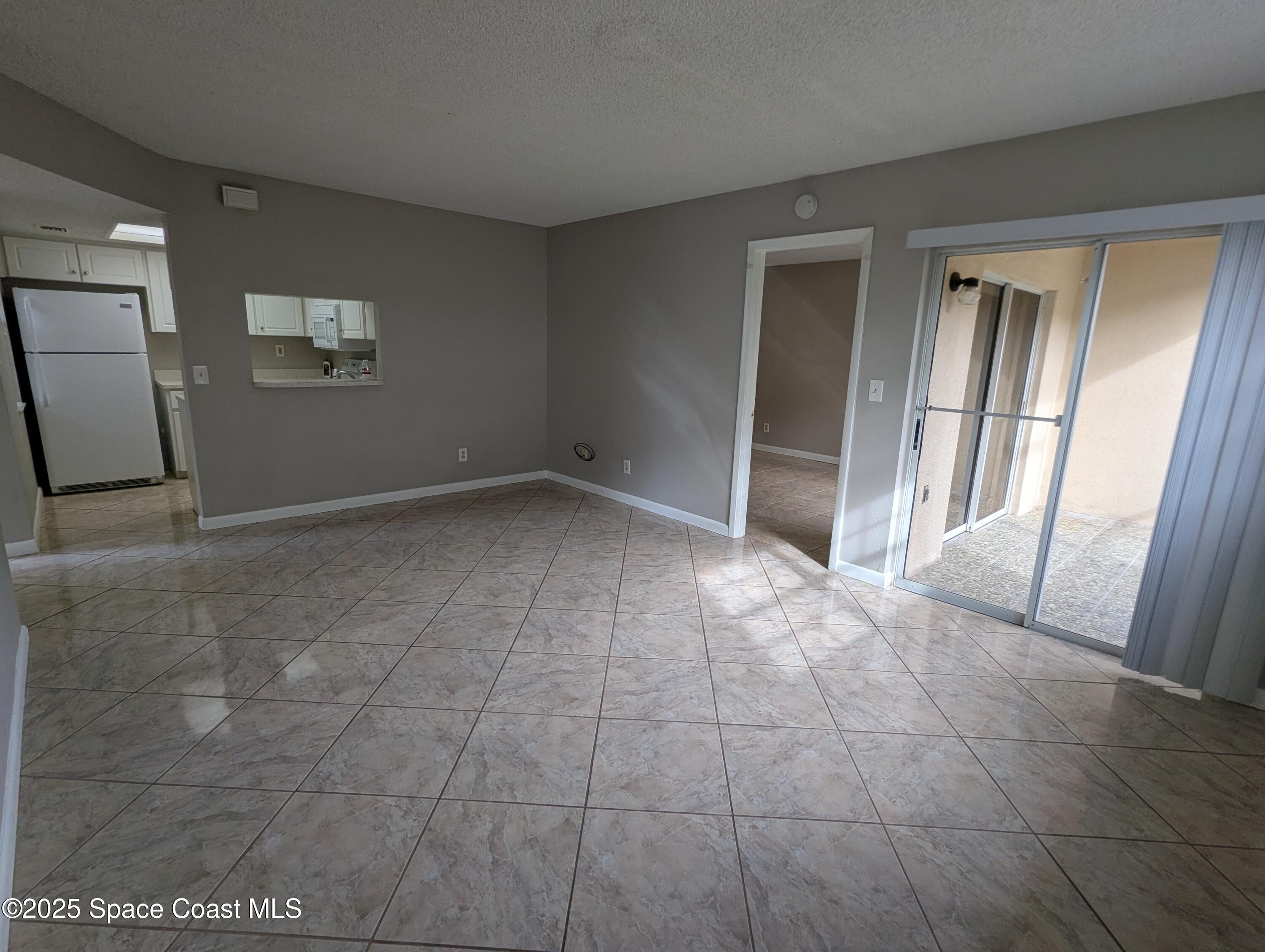 1609 Sunny Brook Lane, Unit E 104 Palm Bay, FL 32905 - Photo 6 of 31 a view of an empty room and a window
