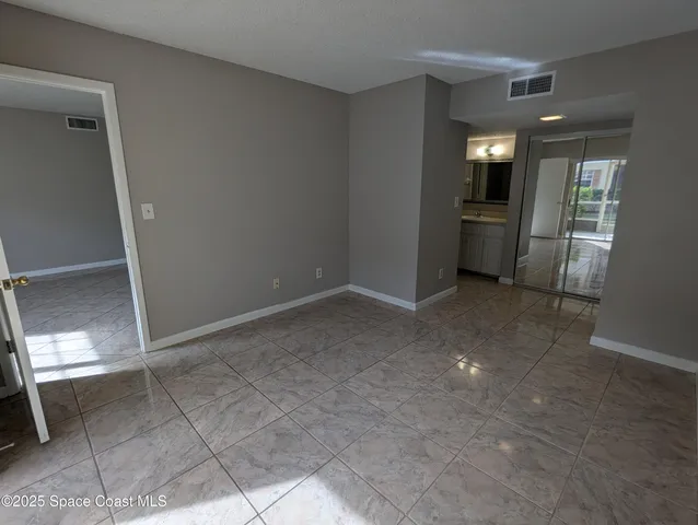 a view of a kitchen cabinets and an empty room
