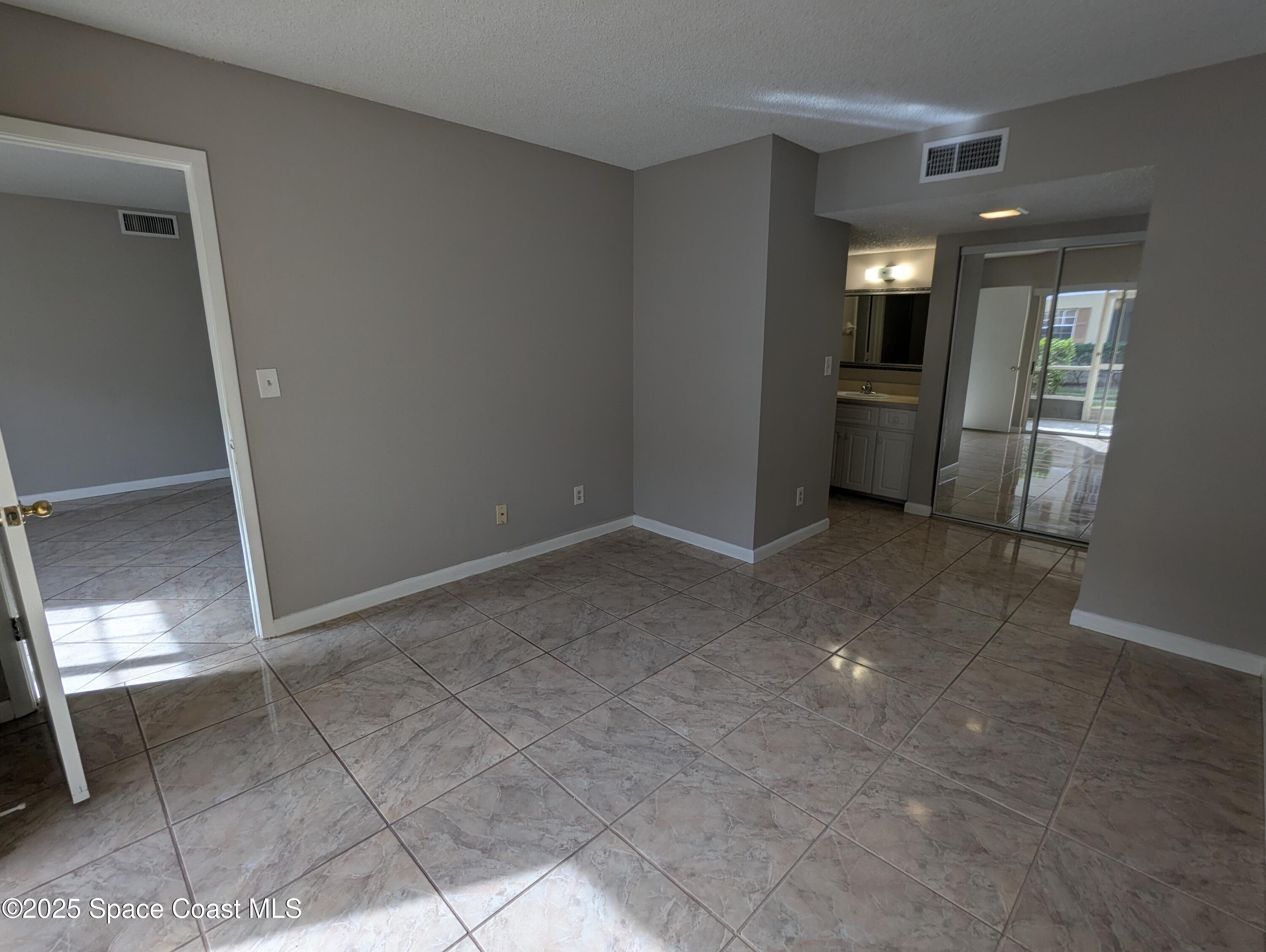 1609 Sunny Brook Lane, Unit E 104 Palm Bay, FL 32905 - Photo 9 of 31 a view of a kitchen cabinets and an empty room