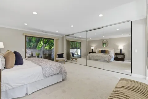 a bedroom with a large bed and a large window