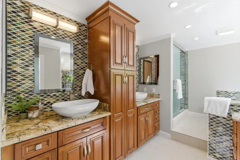 a spacious bathroom with a granite countertop sink and a mirror