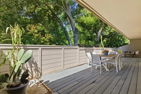 a view of a patio with table and chairs and potted plants