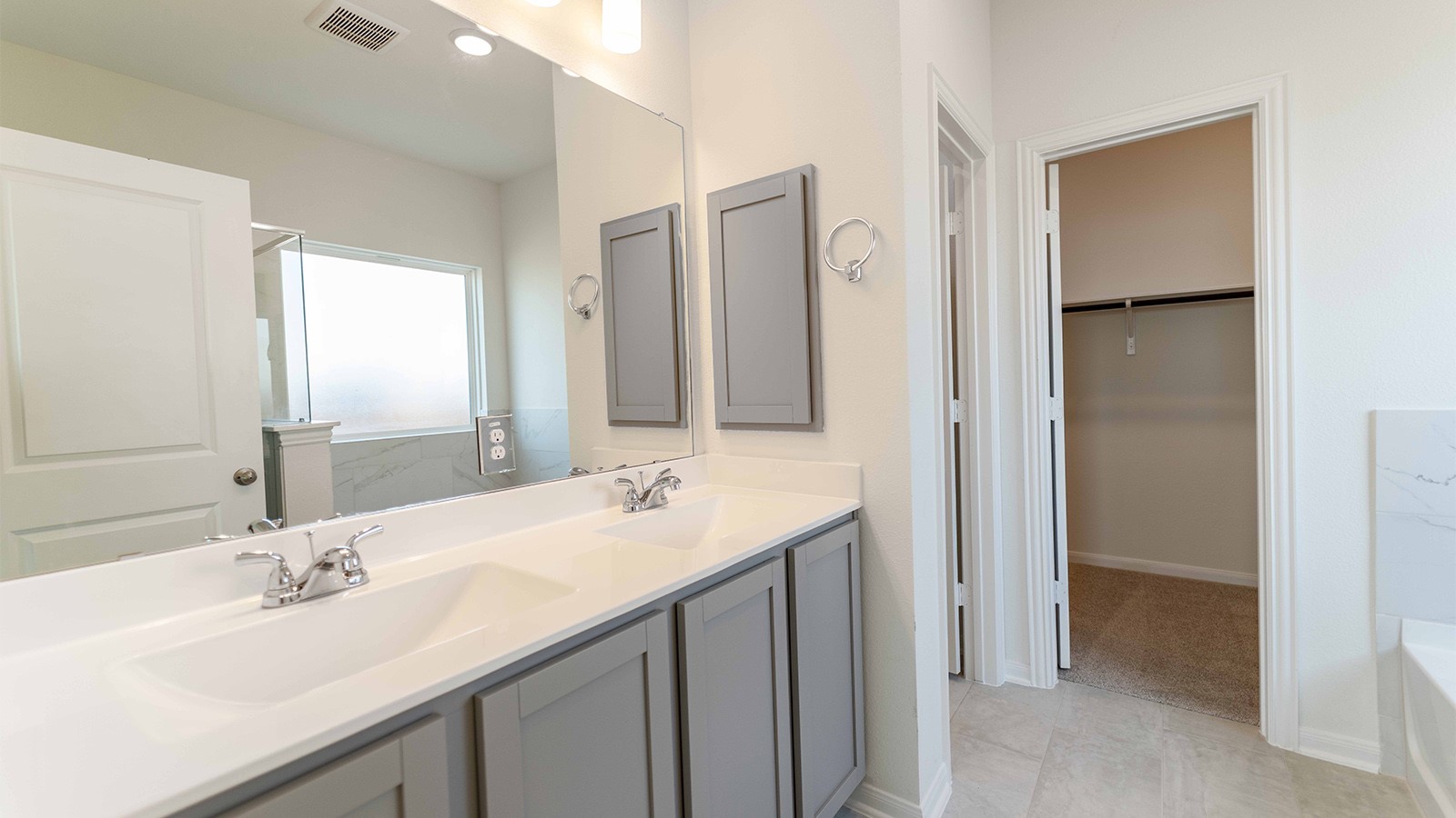 13621 Endless Narrow Lane Elgin, TX 78621 - Photo 17 of 19 a bathroom with a sink double vanity and a mirror