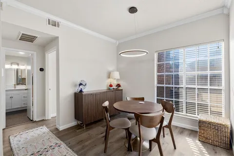 a view of a dining room with furniture and wooden floor