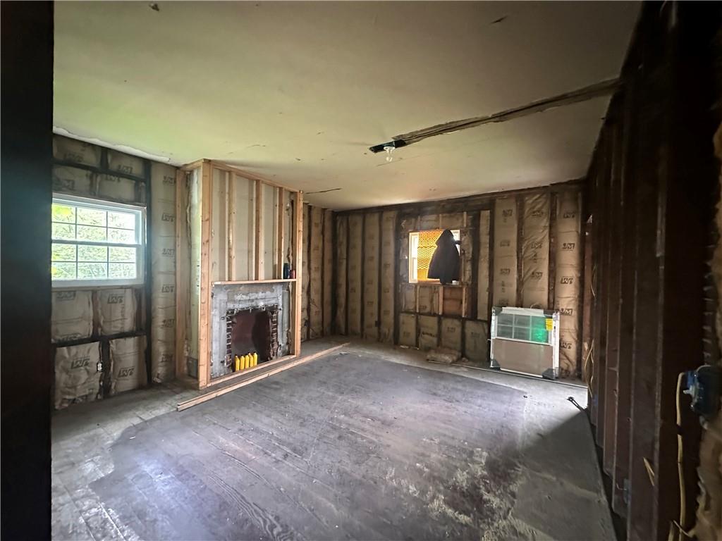 112 Laughlin Street Dawson, PA 15428 - Photo 5 of 15 a view of an empty room with a fireplace and a window