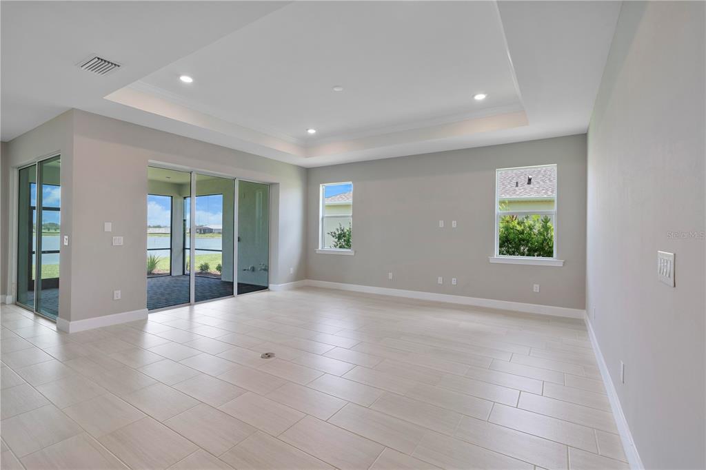 16056 Shoreline Drive Punta Gorda, FL 33982 - Photo 12 of 57 wooden floor in an empty room with a window