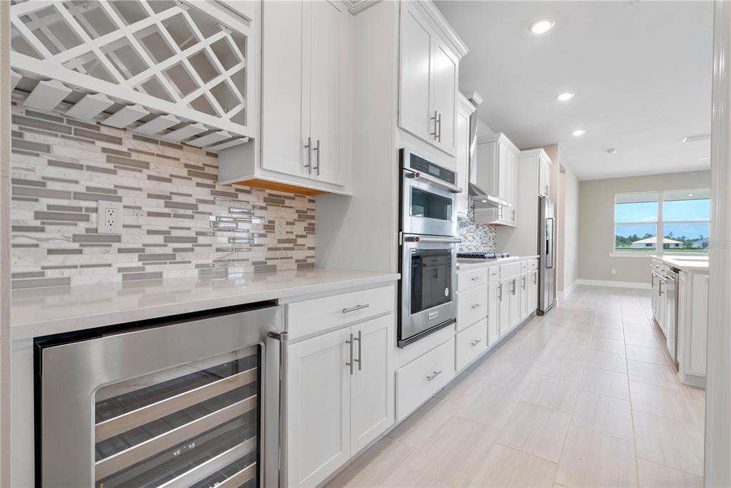 16056 Shoreline Drive Punta Gorda, FL 33982 - Photo 15 of 57 a kitchen with stainless steel appliances kitchen island granite countertop a sink and cabinets