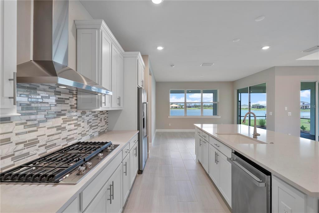 16056 Shoreline Drive Punta Gorda, FL 33982 - Photo 17 of 57 a large kitchen with kitchen island granite countertop a sink and a stove