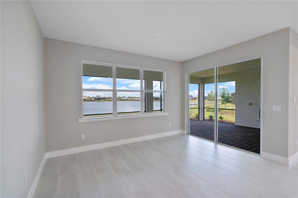 16056 Shoreline Drive Punta Gorda, FL 33982 - Photo 18 of 57 an empty room with wooden floor and windows