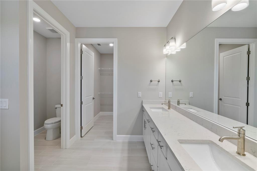 16056 Shoreline Drive Punta Gorda, FL 33982 - Photo 25 of 57 a bathroom with a double vanity sink toilet and shower