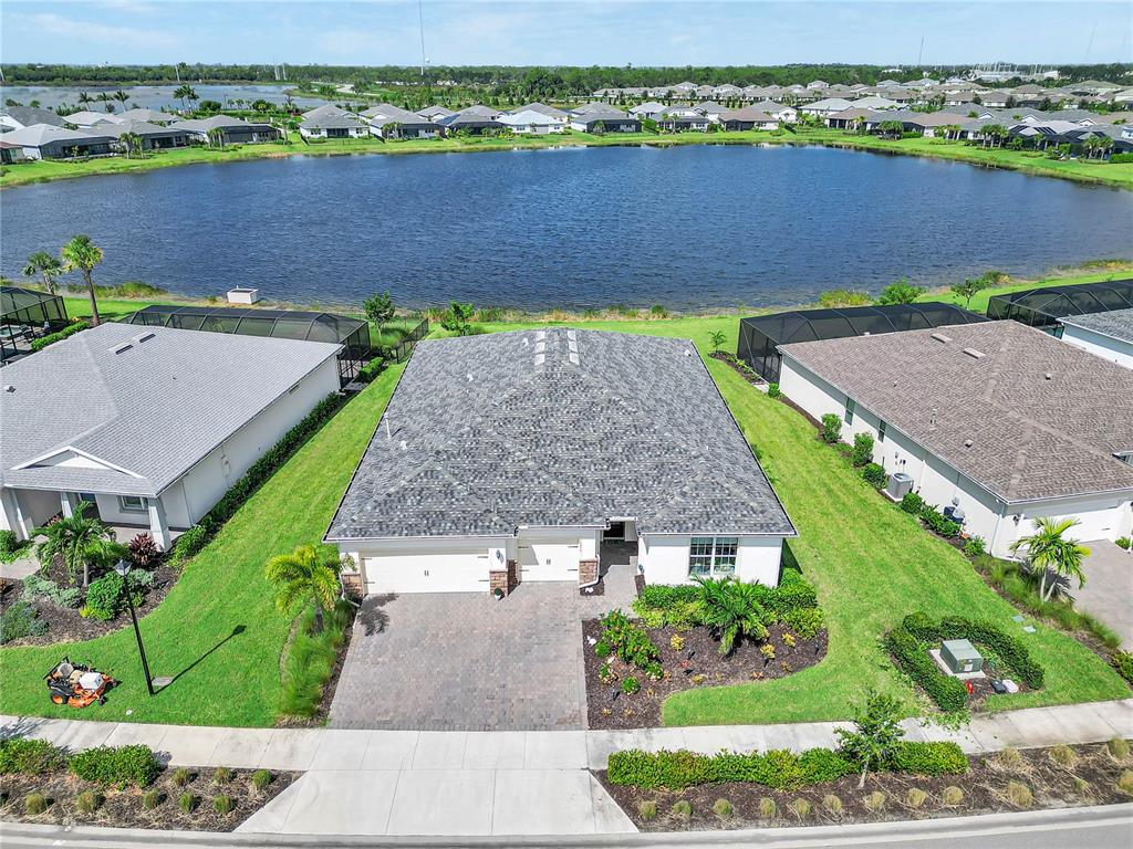16056 Shoreline Drive Punta Gorda, FL 33982 - Photo 37 of 57 an aerial view of a house with a garden and a car parked