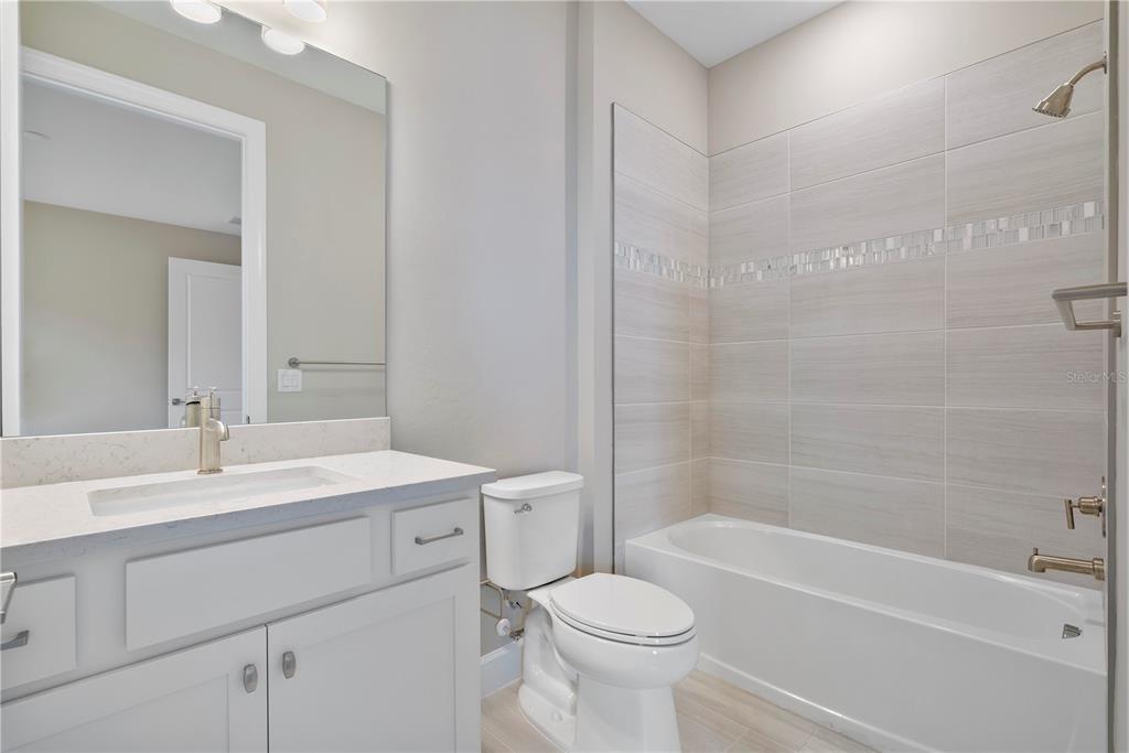 16056 Shoreline Drive Punta Gorda, FL 33982 - Photo 6 of 57 a bathroom with a sink a toilet and a bathtub