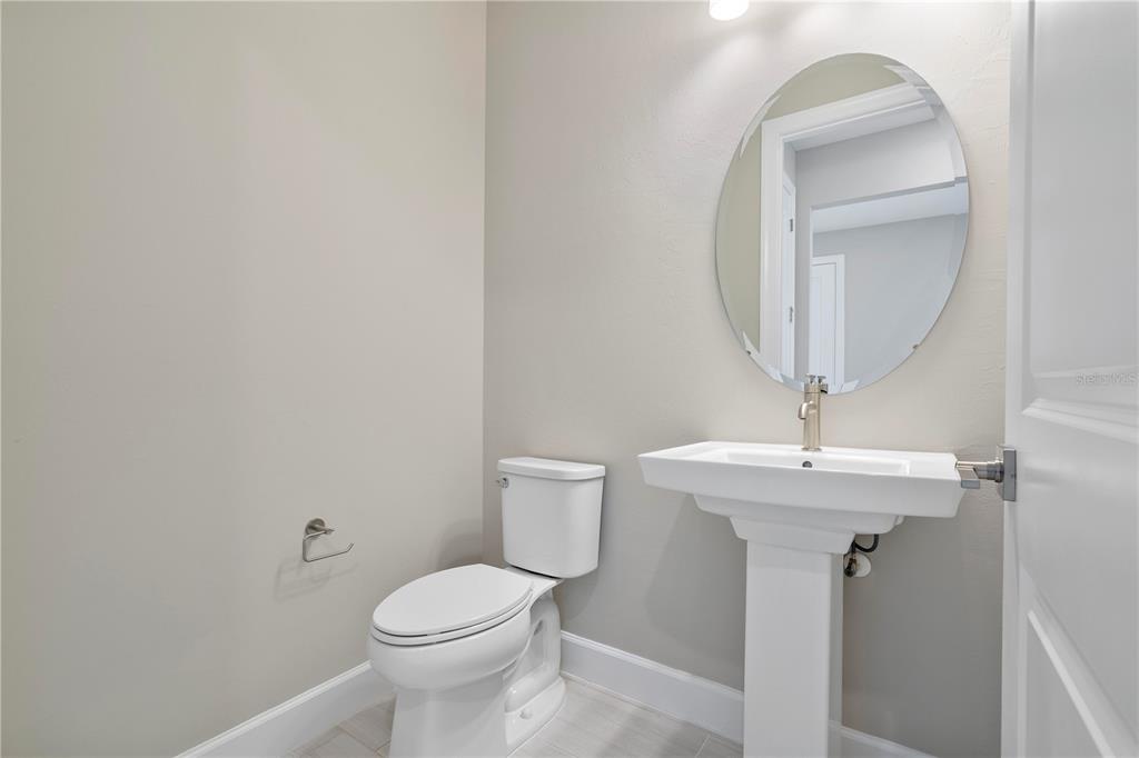 16056 Shoreline Drive Punta Gorda, FL 33982 - Photo 8 of 57 a bathroom with a toilet a sink and mirror