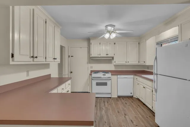 a kitchen with cabinets stainless steel appliances and a counter space